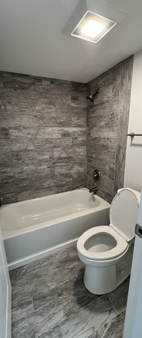 2303 Holiday Terrace, Unit 41 Lansing, IL 60438 - Photo 9 of 11 a bathroom with a toilet and a shower