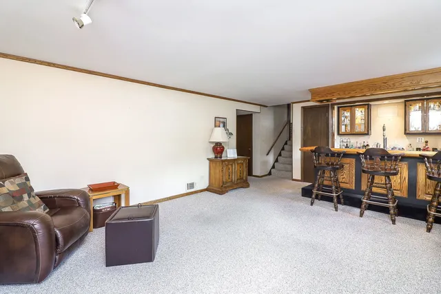a living room with furniture and a air conditioner vent