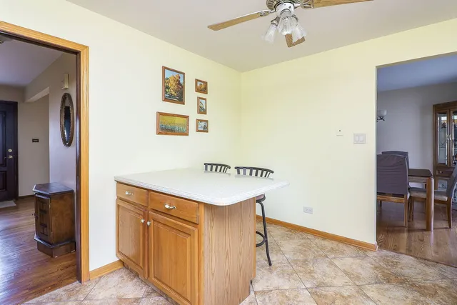 a kitchen with a sink refrigerator and cabinets