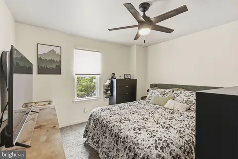 a bedroom with a bed and window