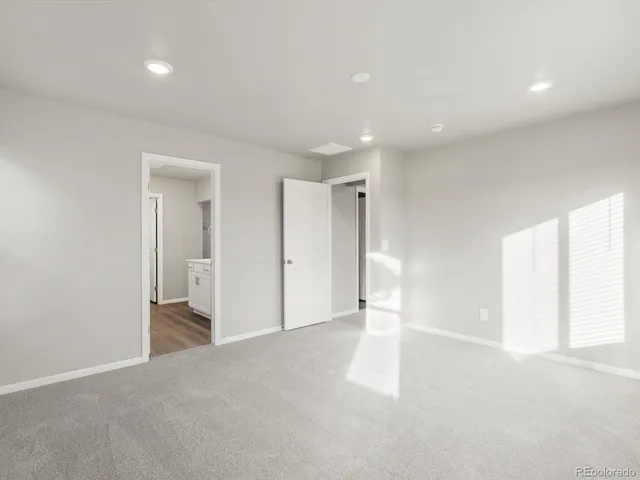 an empty room with windows and closet