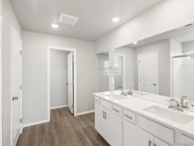 a bathroom with a double vanity sink and mirror