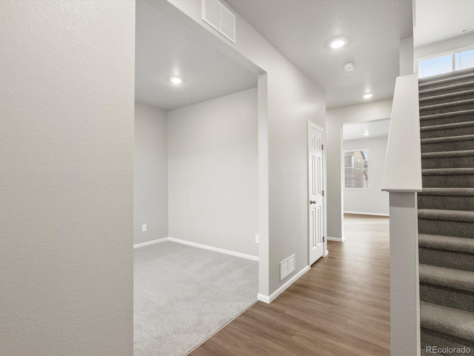 4674 Rabbitbrush Street Johnstown, CO 80534 - Photo 3 of 29 a view of a hallway with wooden floor
