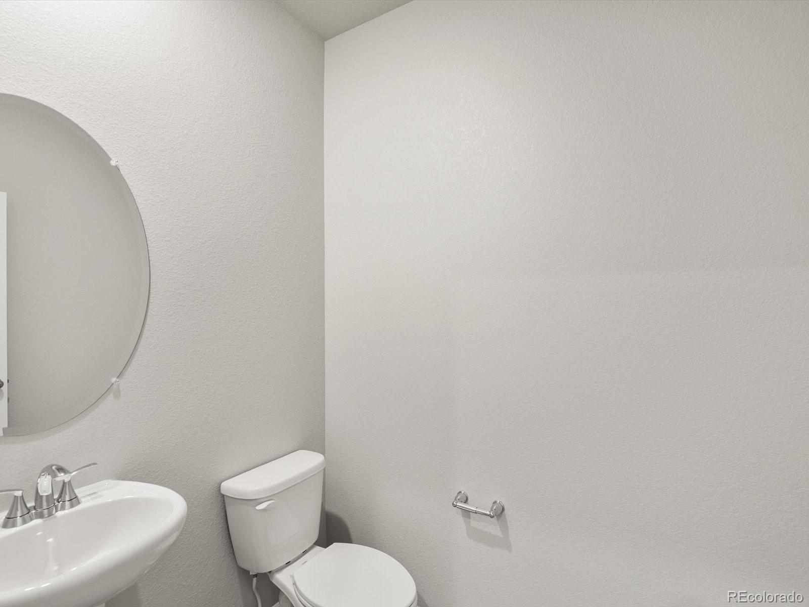 4674 Rabbitbrush Street Johnstown, CO 80534 - Photo 5 of 29 a bathroom with a toilet a sink and mirror