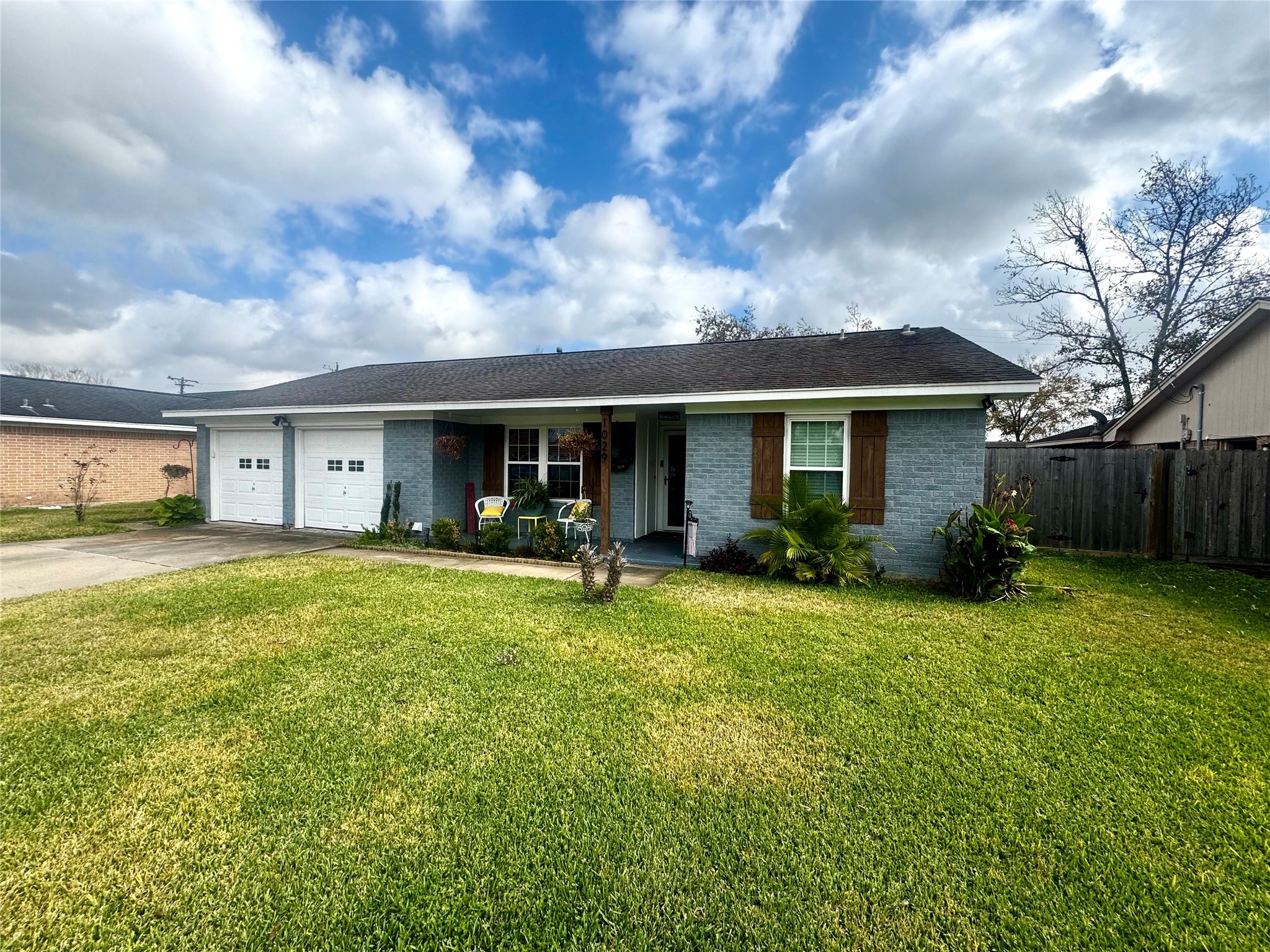 a front view of a house with yard patio and green space