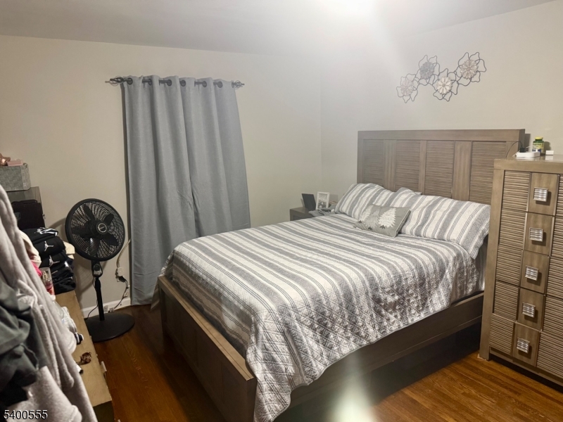 723 Thomas Street, Unit 1L Elizabeth, NJ 07202 - Photo 2 of 7 a bedroom with a bed and a dresser
