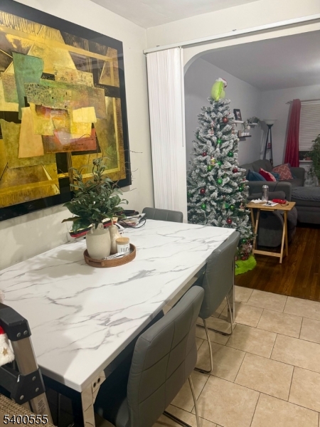 723 Thomas Street, Unit 1L Elizabeth, NJ 07202 - Photo 3 of 7 a dining table with a potted plant