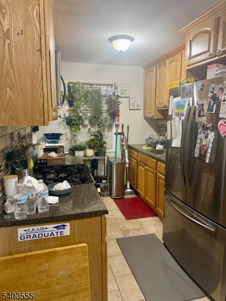 723 Thomas Street, Unit 1L Elizabeth, NJ 07202 - Photo 5 of 7 a kitchen with stainless steel appliances granite countertop a refrigerator and a stove