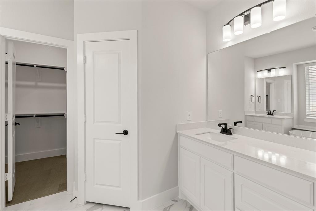 1317 Flamingo Road Forney, TX 75126 - Photo 13 of 39 a bathroom with a sink and a mirror