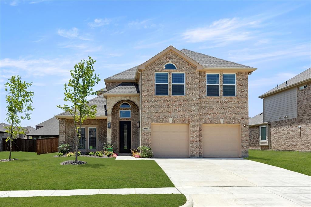 1317 Flamingo Road Forney, TX 75126 - Photo 2 of 39 a front view of a house with a yard
