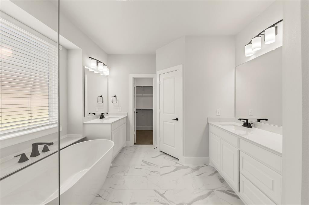 1317 Flamingo Road Forney, TX 75126 - Photo 27 of 39 a spacious bathroom with a tub sink and mirror