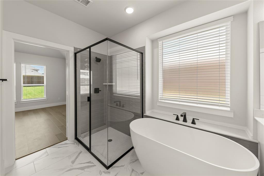 1317 Flamingo Road Forney, TX 75126 - Photo 29 of 39 a bathroom with a bathtub and a shower