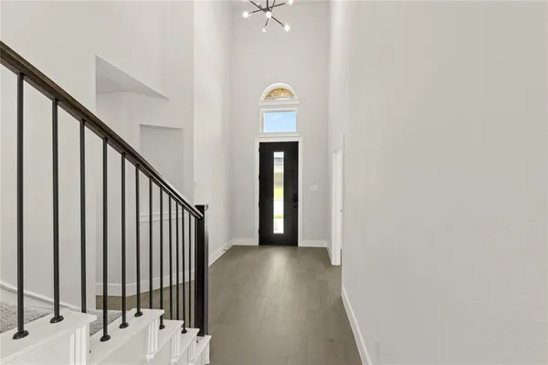 a view of a livingroom with wooden floor and a ceiling fan