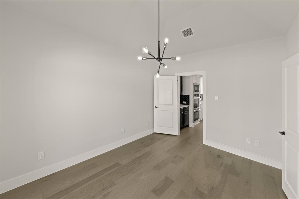 1317 Flamingo Road Forney, TX 75126 - Photo 31 of 39 a view of an empty room with a kitchen