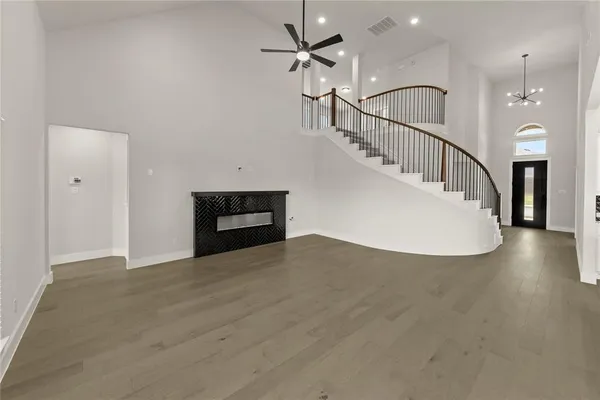 an empty room with windows and fireplace