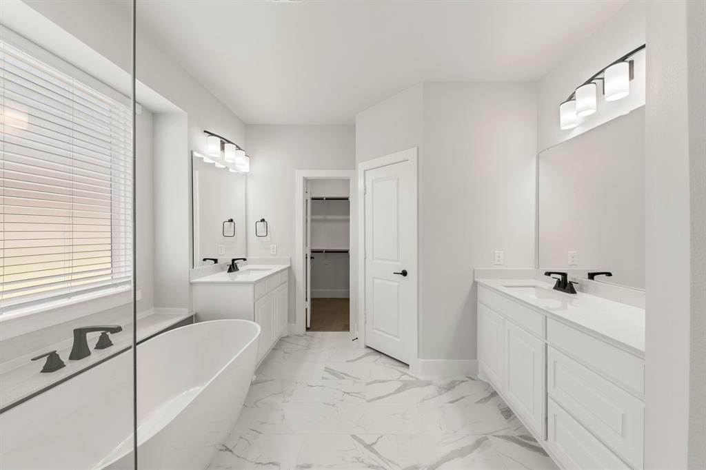 1317 Flamingo Road Forney, TX 75126 - Photo 10 of 39 a spacious bathroom with a tub sink and mirror
