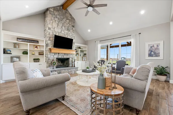 a living room with furniture and a wooden floor