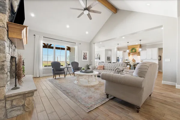 a kitchen with stainless steel appliances granite countertop a kitchen island a stove a table and chairs in it