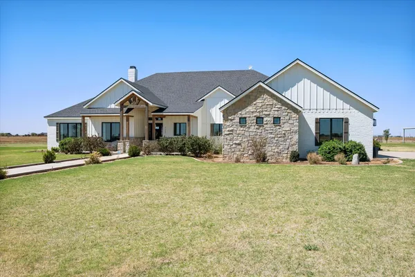 a front view of a house with a lots of potted plants