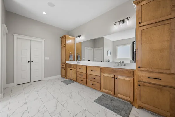 a kitchen with stainless steel appliances granite countertop a sink and cabinets with wooden floor