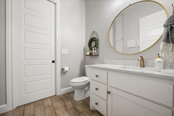 a living room with patio furniture and a garden