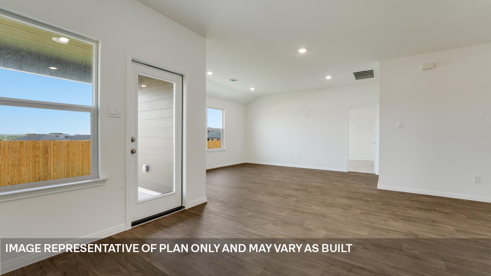 298 Mountain Pea Road Kyle, TX 78640 - Photo 7 of 21 an empty room with wooden floor and windows
