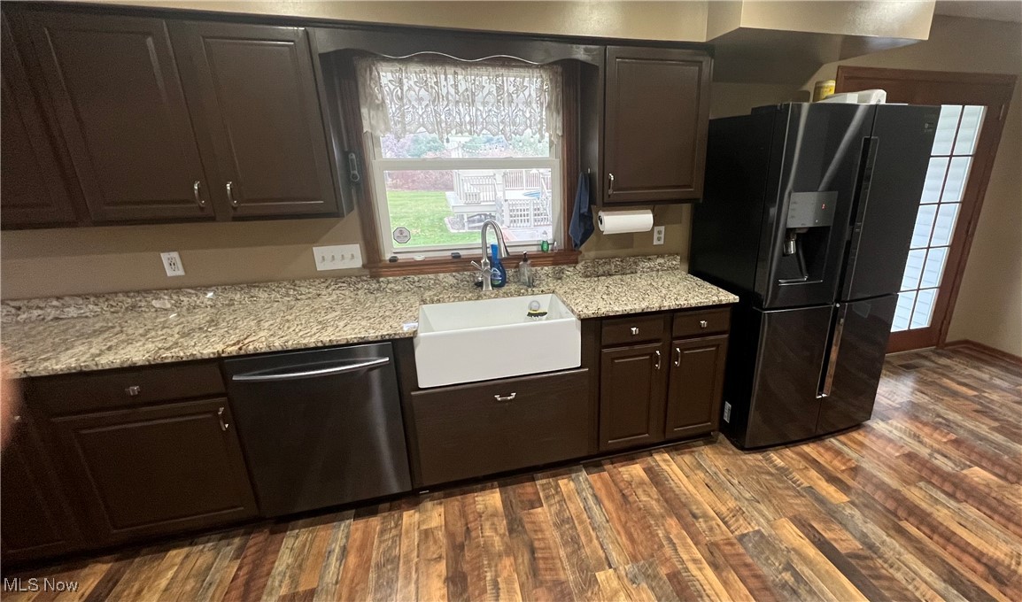 11525 Rapp Road New Middletown, OH 44442 - Photo 11 of 32 Kitchen with black fridge with ice dispenser, stainless steel dishwasher, dark brown cabinets, dark wood-type flooring, and light stone countertops