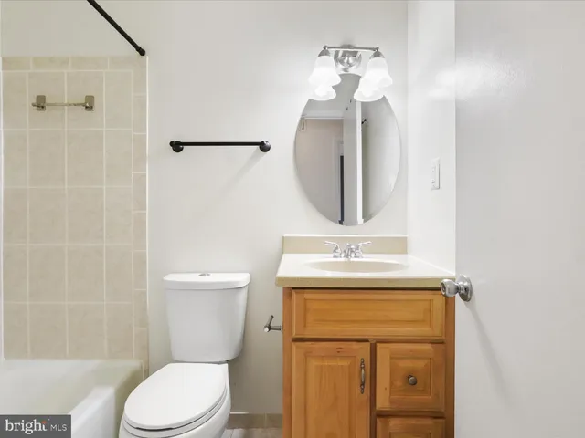 a bathroom with a toilet a sink and shower