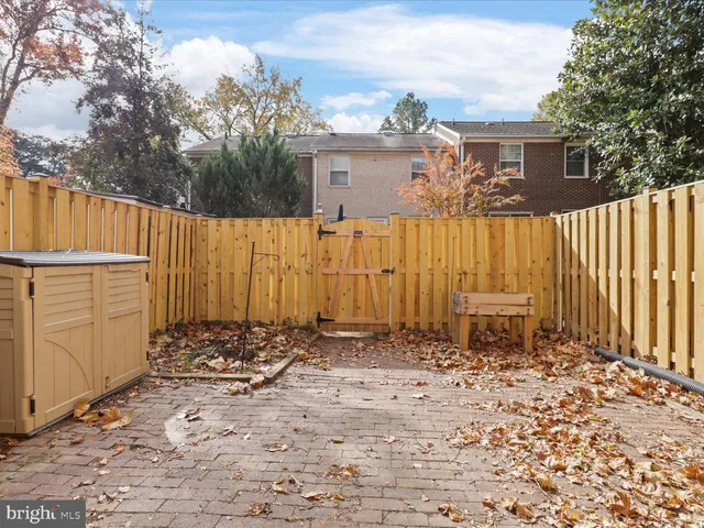 a view of a house with wooden fence