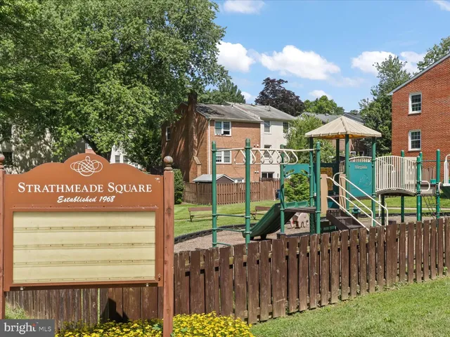 a view of a street with wooden fence