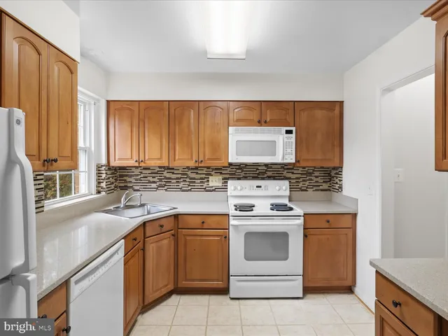 a kitchen with a stove sink and cabinets