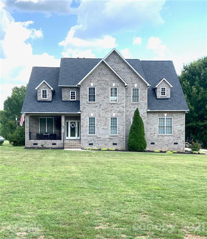 196 Cedar Grove Road York, SC 29745 - Photo 2 of 45 a front view of a house with a garden and trees