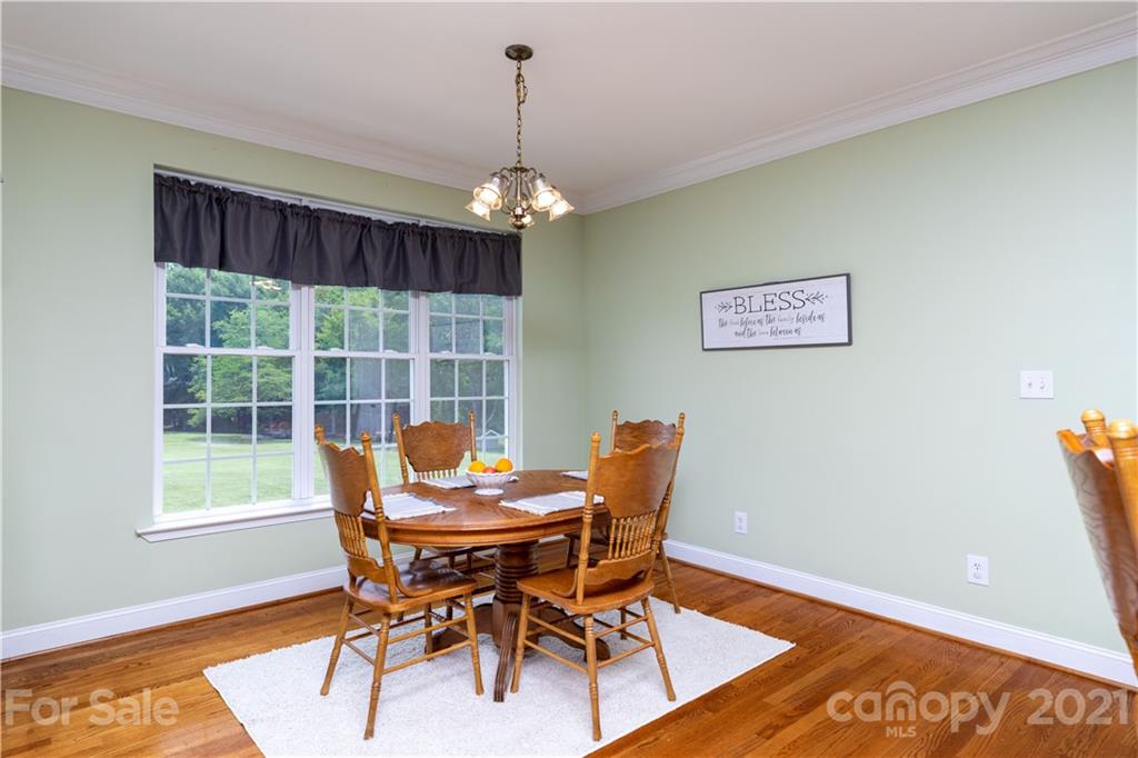 196 Cedar Grove Road York, SC 29745 - Photo 15 of 45 a dining room with furniture a rug and a chandelier