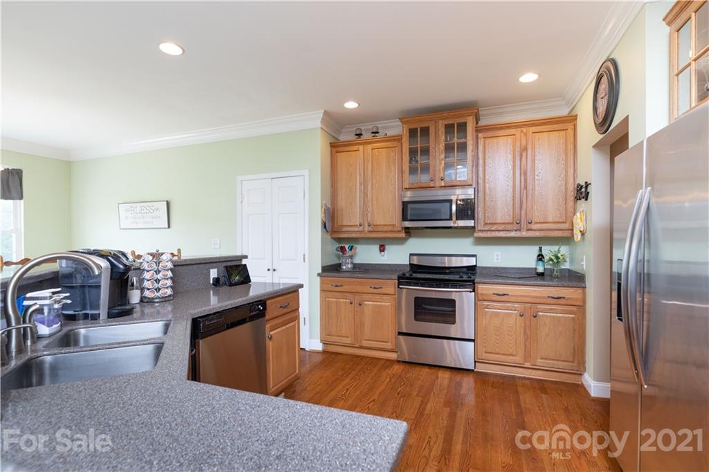 196 Cedar Grove Road York, SC 29745 - Photo 18 of 45 a kitchen with granite countertop a stove top oven and refrigerator