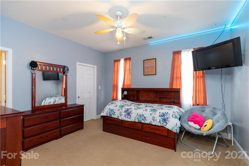 196 Cedar Grove Road York, SC 29745 - Photo 22 of 45 a bedroom with a bed and a flat screen tv