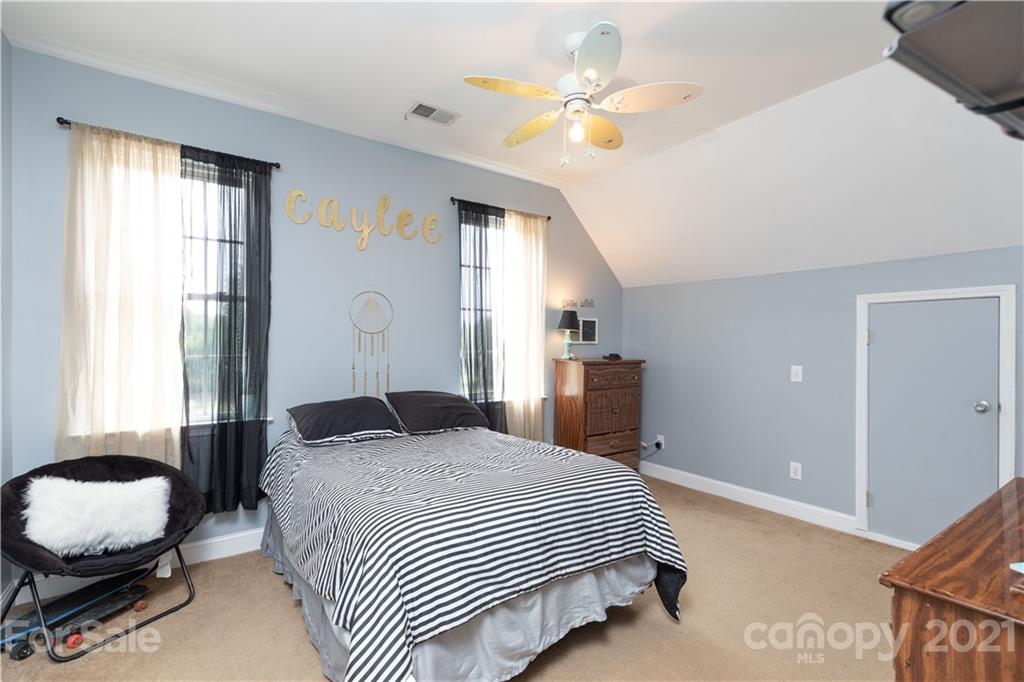 196 Cedar Grove Road York, SC 29745 - Photo 25 of 45 a bedroom with a bed and a chandelier