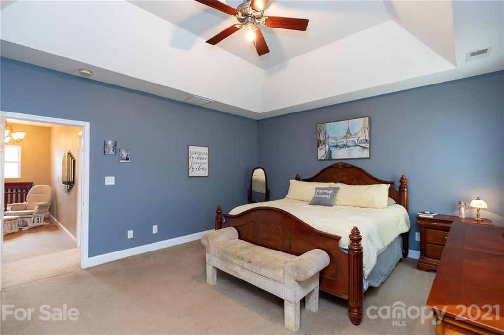 196 Cedar Grove Road York, SC 29745 - Photo 28 of 45 a bedroom with a bed and a chandelier
