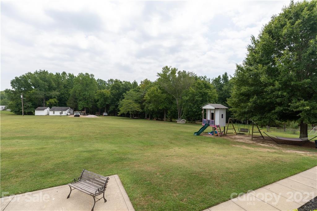 196 Cedar Grove Road York, SC 29745 - Photo 40 of 45 a view of a garden with a slide