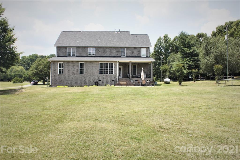 196 Cedar Grove Road York, SC 29745 - Photo 6 of 45 a front view of house with yard and trees in the background