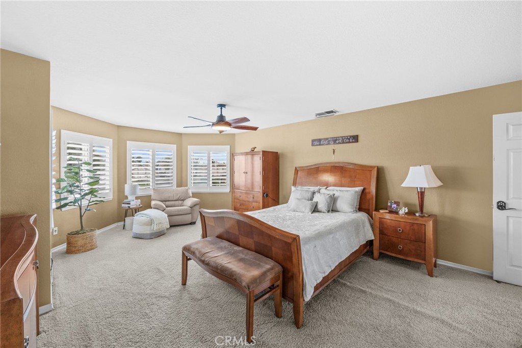 20257 Edmund Road Riverside, CA 92508 - Photo 27 of 53 a spacious bedroom with a bed and a couch