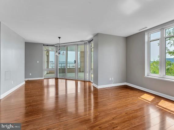 100 Harborview Drive, Unit 202 Baltimore, MD 21230 - Photo 17 of 25 a view of an empty room with wooden floor and a window