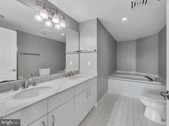 a bathroom with a granite countertop sink mirror and toilet