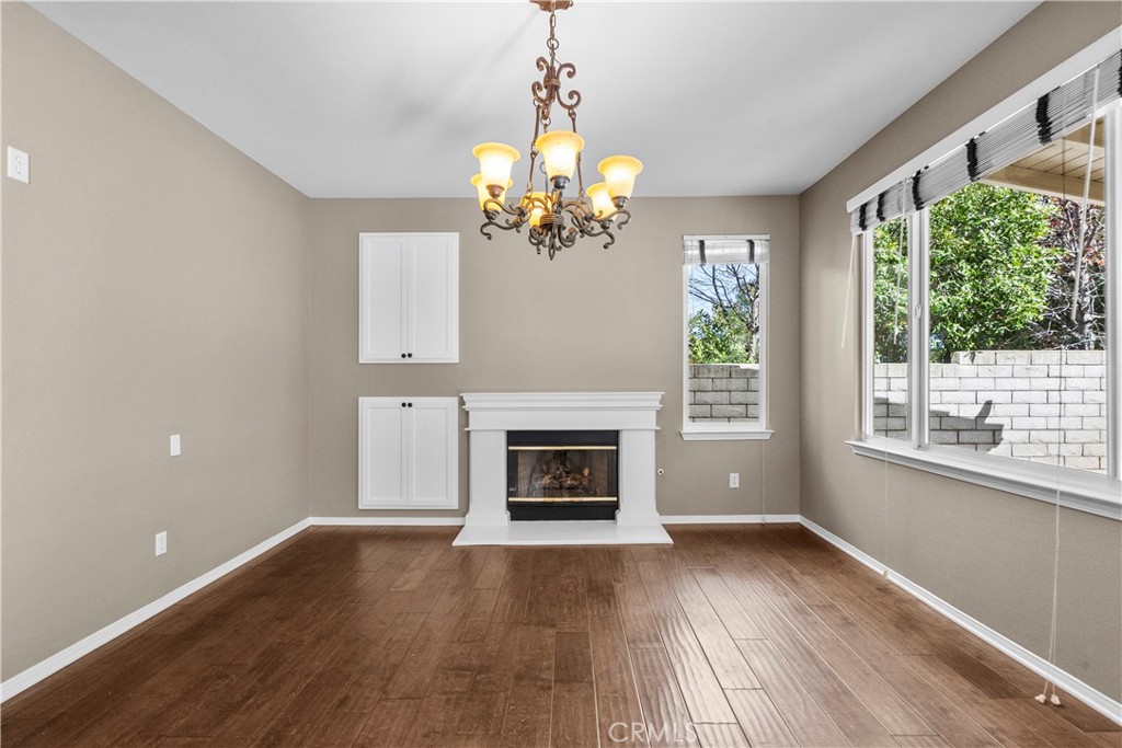 25558 Fitzgerald Avenue Stevenson Ranch, CA 91381 - Photo 14 of 55 a view of a room with wooden floor fireplace and windows