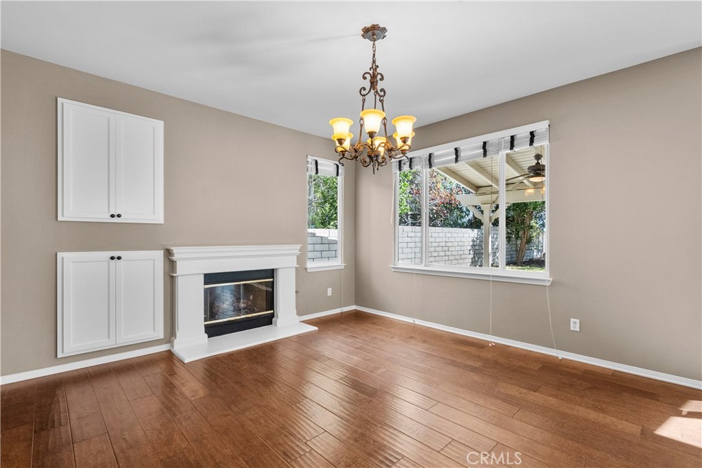 25558 Fitzgerald Avenue Stevenson Ranch, CA 91381 - Photo 15 of 55 a view of a room with wooden floor fireplace and window