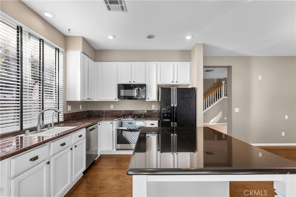 25558 Fitzgerald Avenue Stevenson Ranch, CA 91381 - Photo 18 of 55 a kitchen with stainless steel appliances granite countertop a stove a sink and a refrigerator