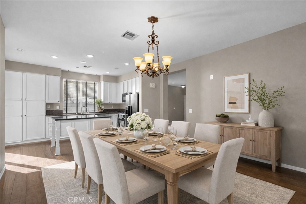 25558 Fitzgerald Avenue Stevenson Ranch, CA 91381 - Photo 20 of 55 a dining room with furniture a chandelier and wooden floor