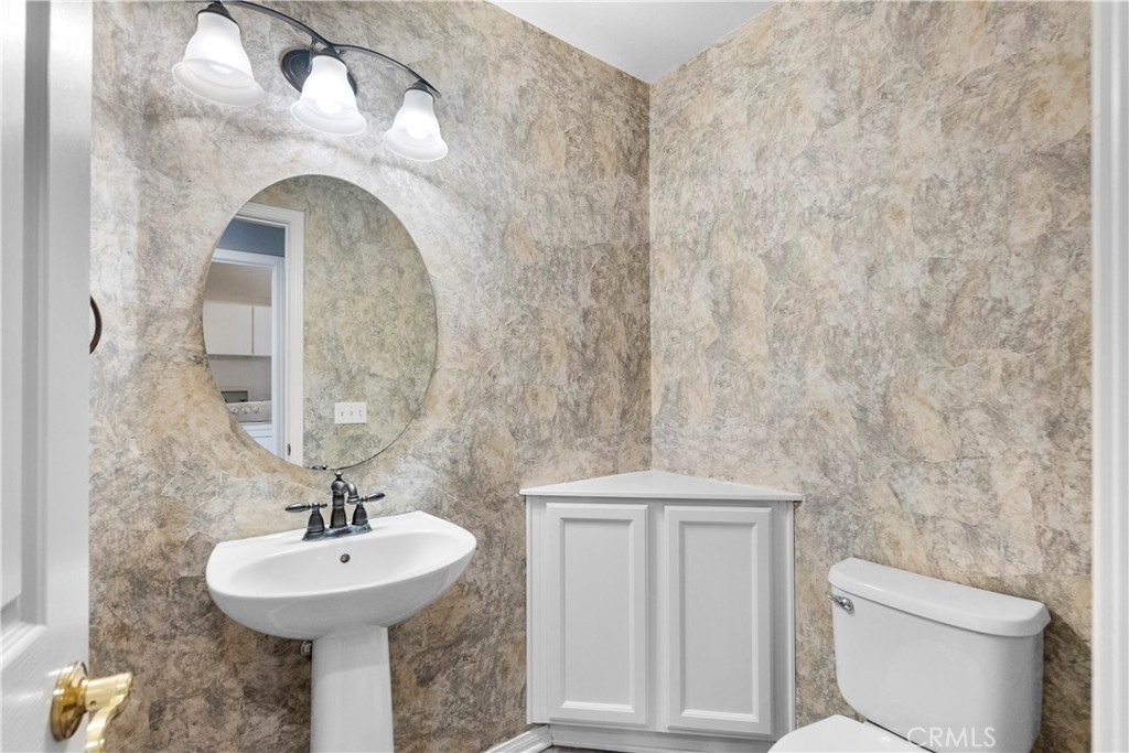 25558 Fitzgerald Avenue Stevenson Ranch, CA 91381 - Photo 24 of 55 a bathroom with a sink a toilet and mirror