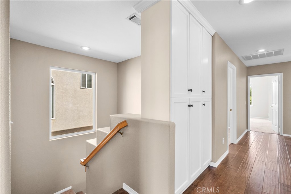 25558 Fitzgerald Avenue Stevenson Ranch, CA 91381 - Photo 27 of 55 a view of a hallway with wooden floor and entryway