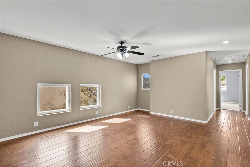 25558 Fitzgerald Avenue Stevenson Ranch, CA 91381 - Photo 29 of 55 a view of an empty room with window and wooden floor