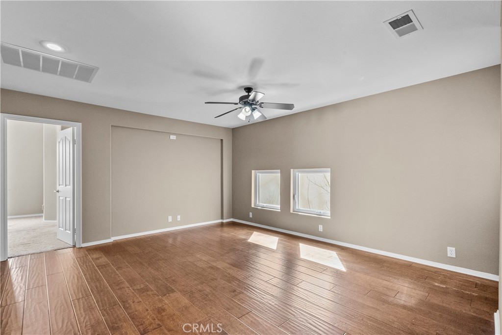 25558 Fitzgerald Avenue Stevenson Ranch, CA 91381 - Photo 30 of 55 a view of an empty room with window and wooden floor